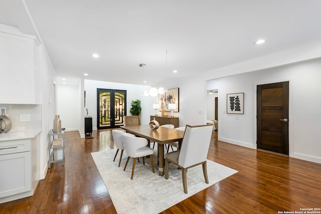 dining room with french doors and dark hardwood / wood-style floors