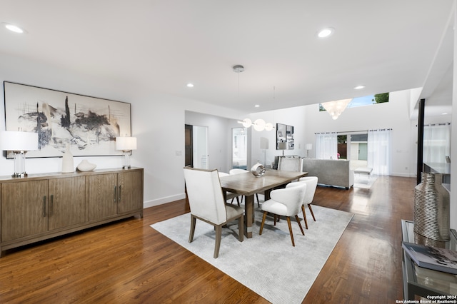 dining space featuring dark hardwood / wood-style floors and a chandelier