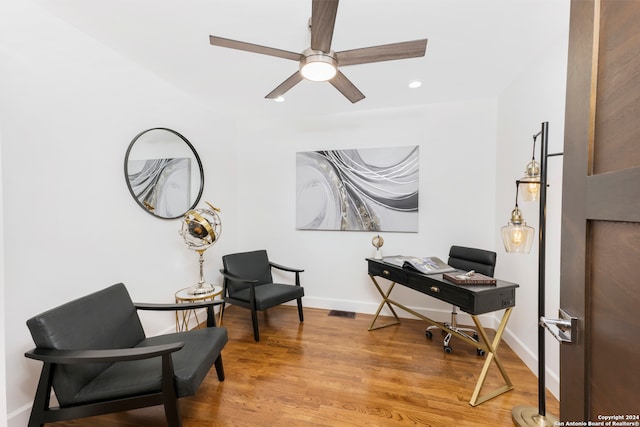 home office with hardwood / wood-style floors and ceiling fan