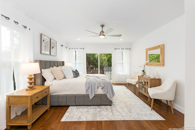 bedroom featuring hardwood / wood-style floors, access to exterior, and multiple windows