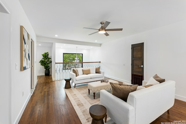 living room with ceiling fan and dark hardwood / wood-style floors