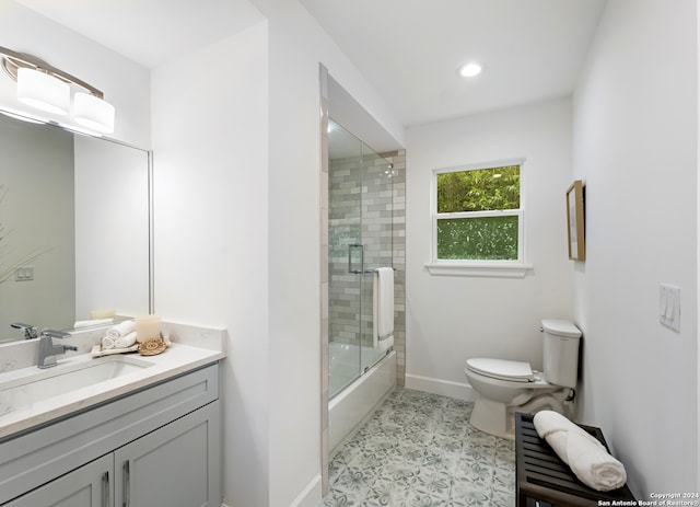 full bathroom with tile patterned floors, vanity, toilet, and enclosed tub / shower combo