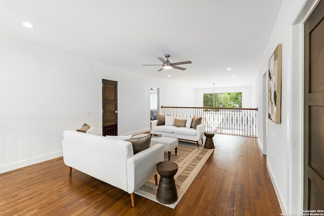 living room with ceiling fan and dark hardwood / wood-style flooring