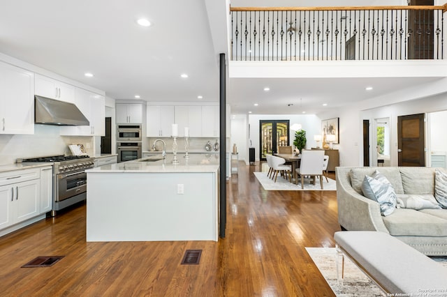 kitchen featuring white cabinets, stainless steel appliances, dark hardwood / wood-style floors, and sink