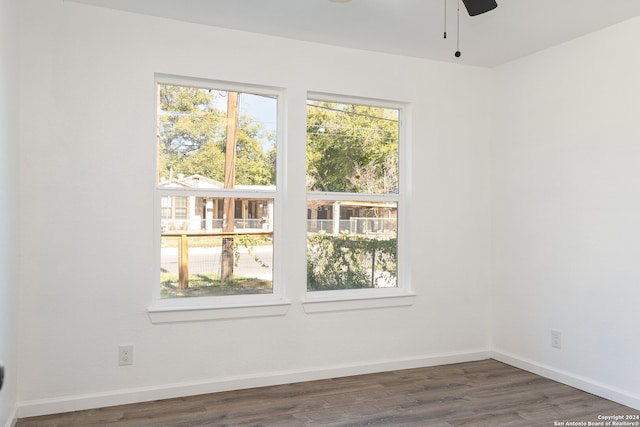 empty room featuring ceiling fan and dark hardwood / wood-style floors