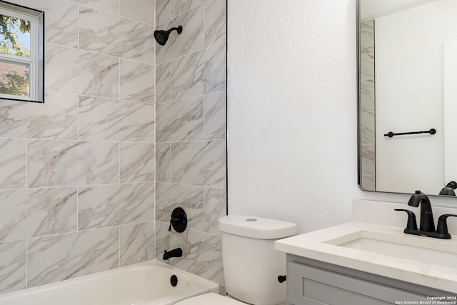 full bathroom featuring toilet, vanity, and tiled shower / bath