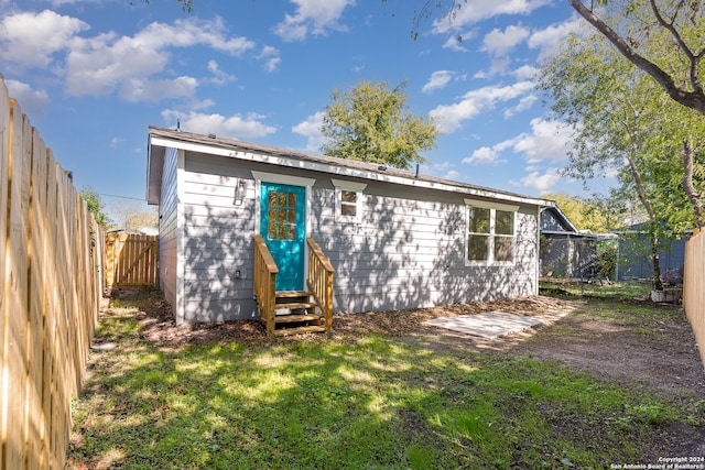 back of house with a yard