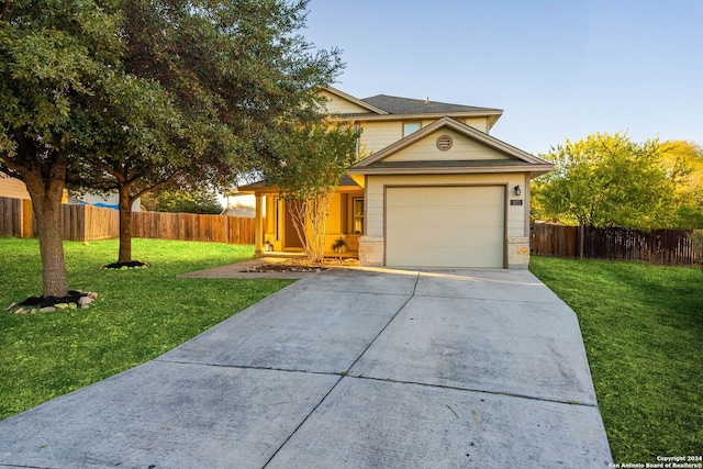 view of front of house featuring a front lawn and a garage