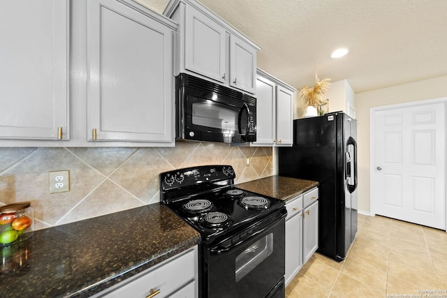 kitchen with black appliances, light tile patterned floors, backsplash, and dark stone counters