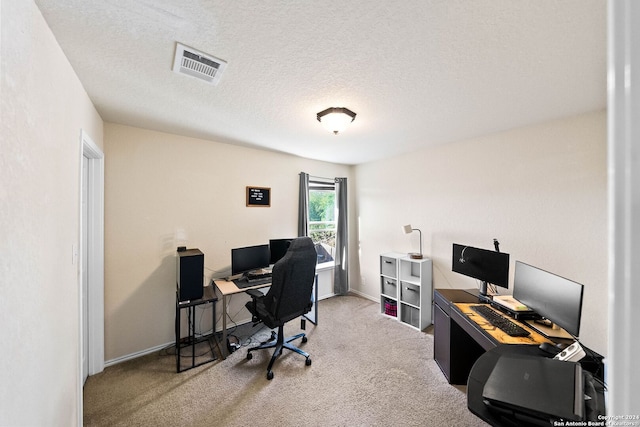 home office with carpet flooring and a textured ceiling