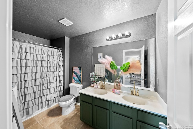 bathroom featuring vanity, tile patterned floors, a shower with curtain, toilet, and a textured ceiling