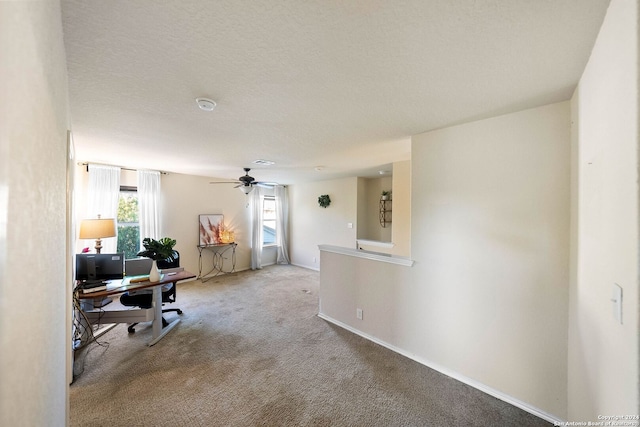 home office featuring a textured ceiling and light colored carpet