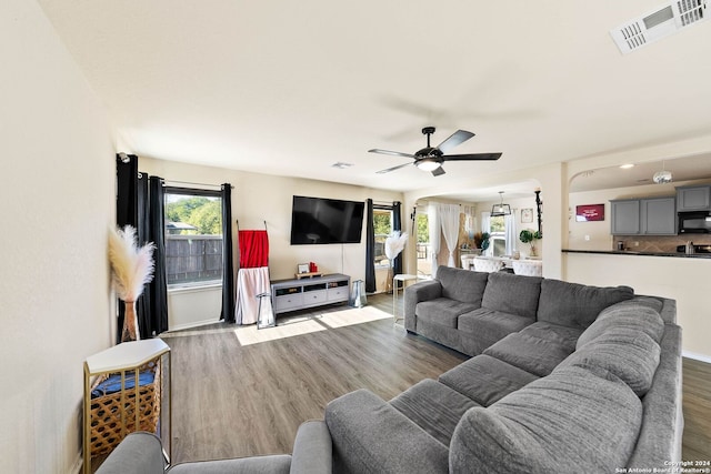 living room featuring hardwood / wood-style floors and ceiling fan