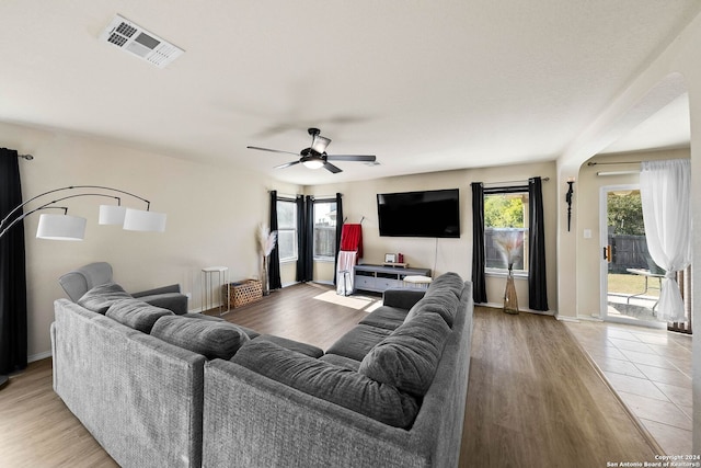 living room featuring light wood-type flooring and ceiling fan