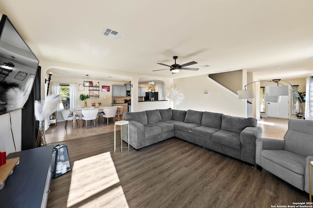 living room featuring dark hardwood / wood-style floors and ceiling fan