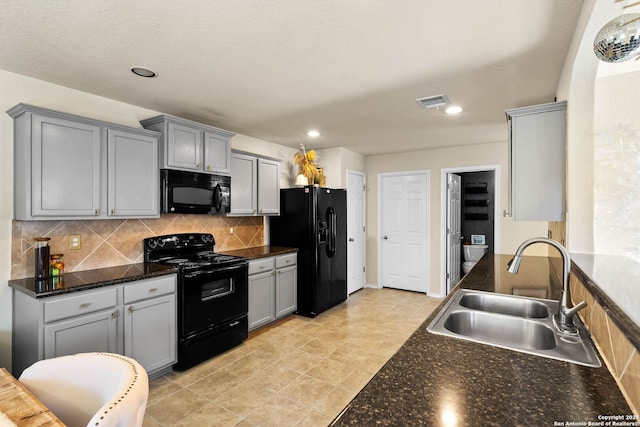 kitchen with sink, gray cabinets, decorative backsplash, light tile patterned flooring, and black appliances