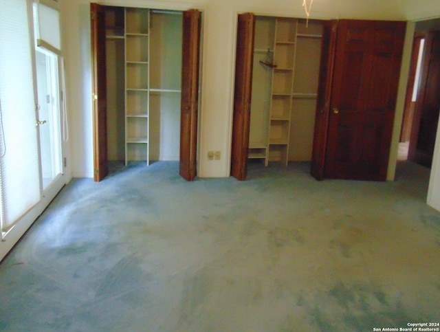 unfurnished bedroom featuring light colored carpet