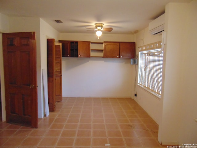 kitchen featuring ceiling fan and a wall unit AC