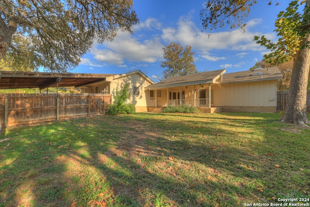 exterior space with a lawn and a carport