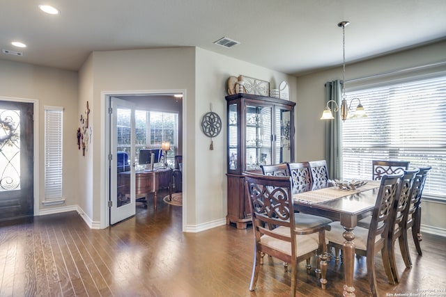 dining area featuring a notable chandelier and dark hardwood / wood-style flooring