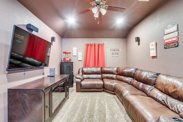 living room featuring ceiling fan, light colored carpet, and lofted ceiling