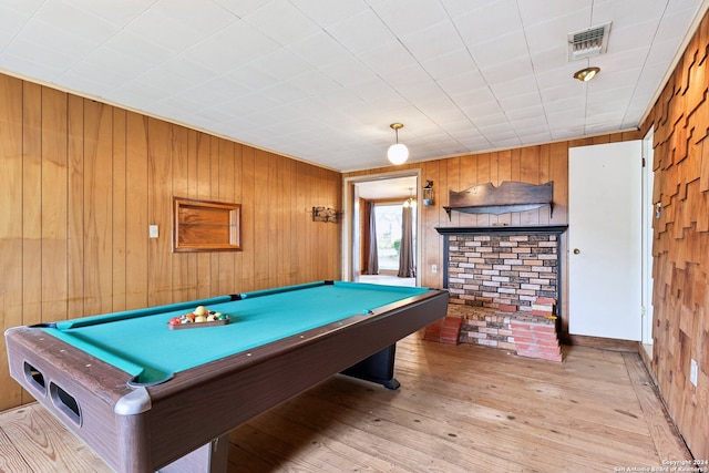 rec room with wood walls, light hardwood / wood-style floors, and billiards