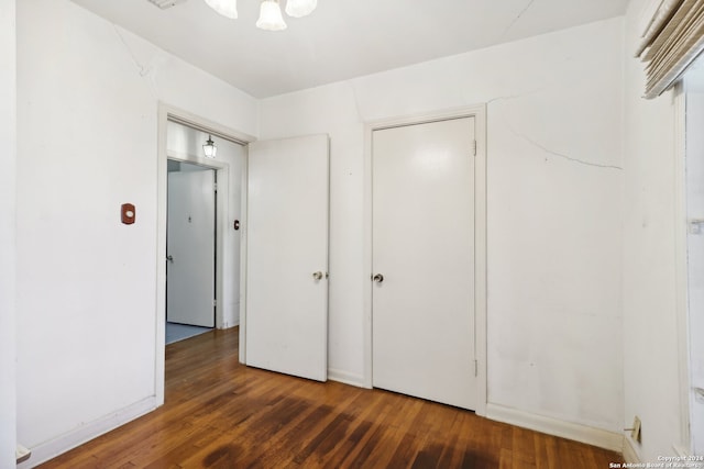 unfurnished bedroom with dark hardwood / wood-style flooring