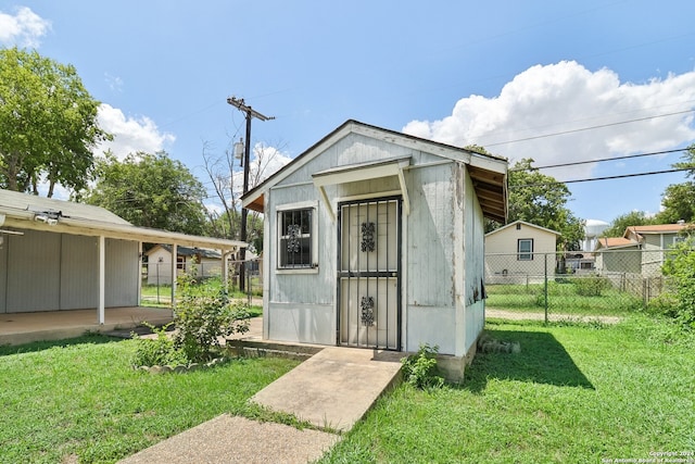 view of outbuilding with a yard