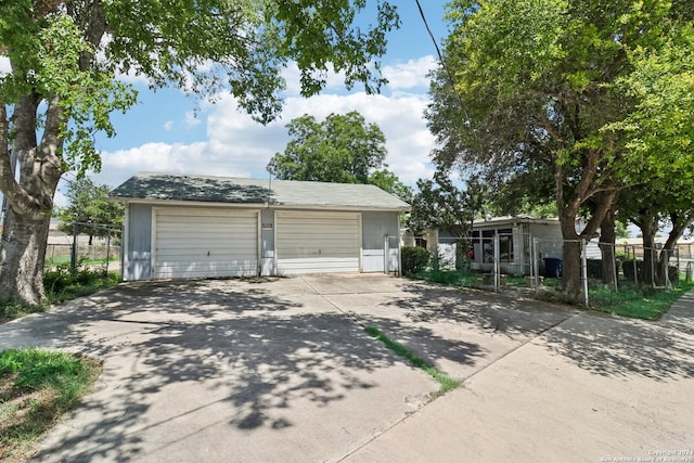 view of front of property featuring a garage and an outdoor structure