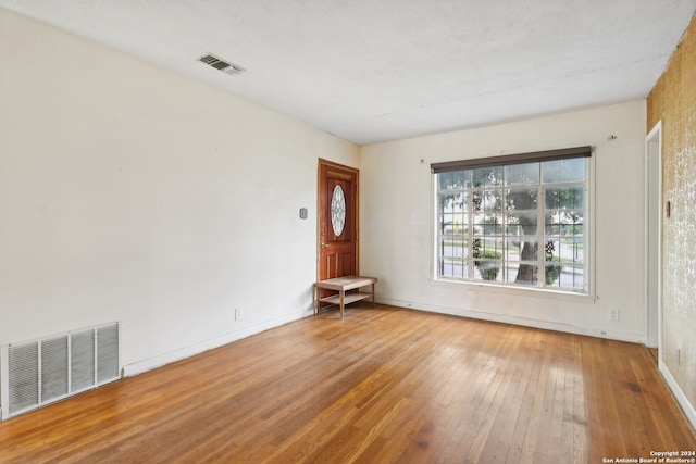 unfurnished room with wood-type flooring