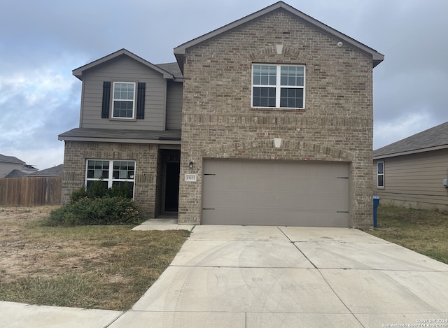 view of front property featuring a garage and a front yard