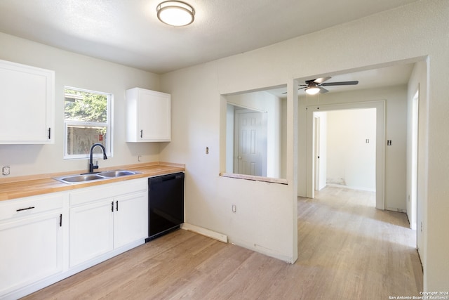 kitchen with sink, light hardwood / wood-style flooring, dishwasher, butcher block countertops, and white cabinetry