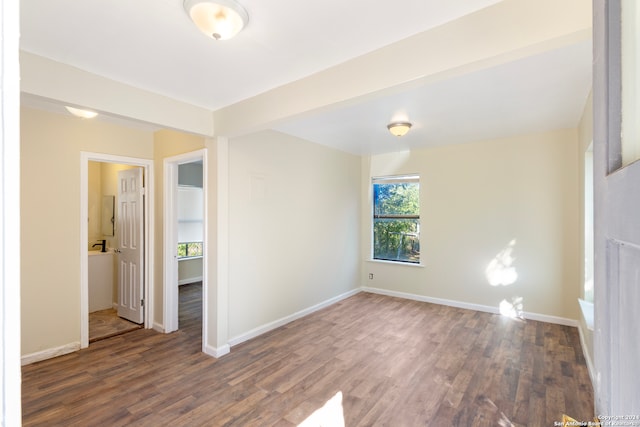 empty room featuring dark hardwood / wood-style flooring