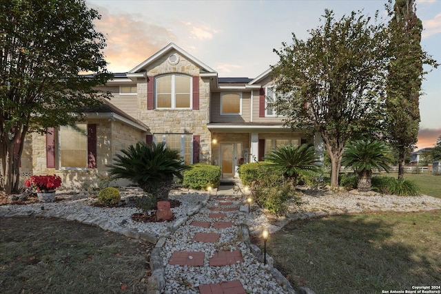 view of front of house featuring a yard and solar panels