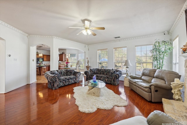 living room featuring ceiling fan, dark hardwood / wood-style flooring, and ornamental molding