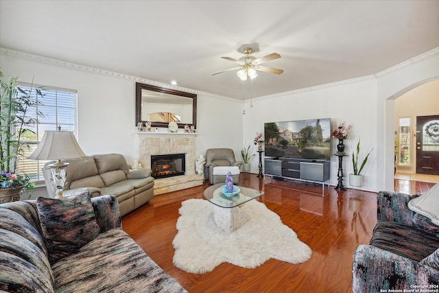 living room with ceiling fan, wood-type flooring, and ornamental molding