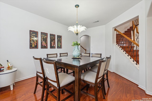 dining room featuring a notable chandelier and hardwood / wood-style flooring