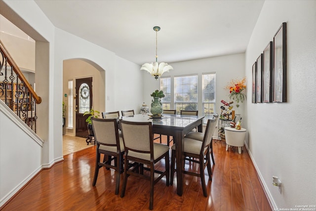 dining area featuring a notable chandelier and dark hardwood / wood-style flooring