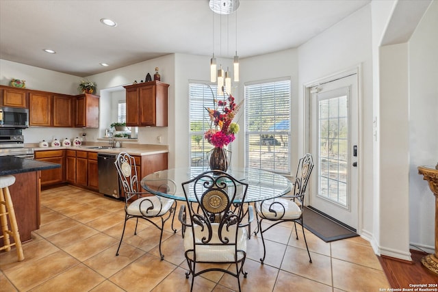 dining room with plenty of natural light, light tile patterned floors, and sink