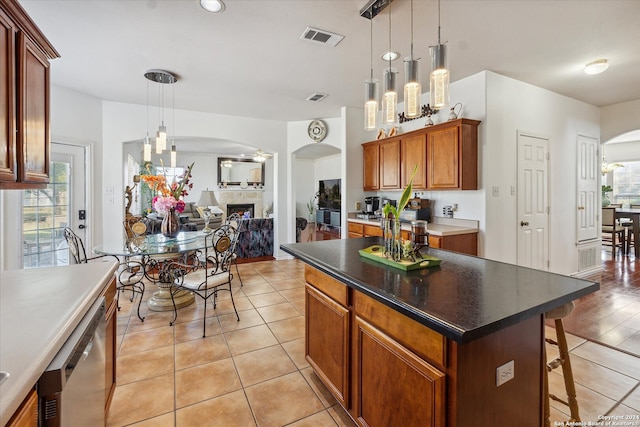 kitchen with dishwasher, a center island, a healthy amount of sunlight, and hanging light fixtures