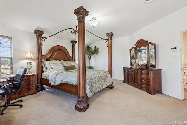 bedroom featuring light carpet and lofted ceiling