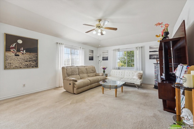 living room with ceiling fan, a healthy amount of sunlight, and light colored carpet