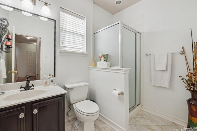 bathroom featuring vanity, toilet, and walk in shower