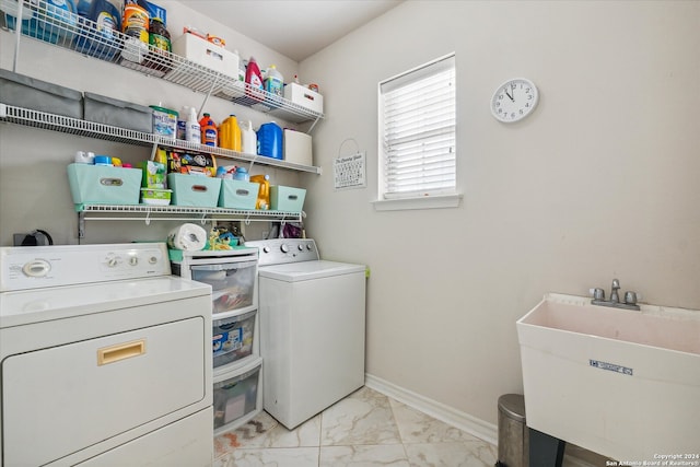 washroom with washer and dryer and sink