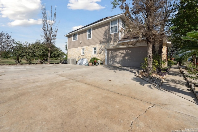 rear view of house with a garage