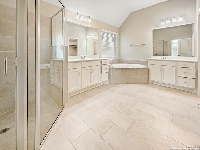 bathroom with tile patterned floors, vanity, plus walk in shower, and vaulted ceiling