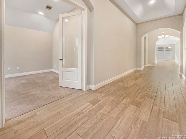 hallway featuring a chandelier and light wood-type flooring