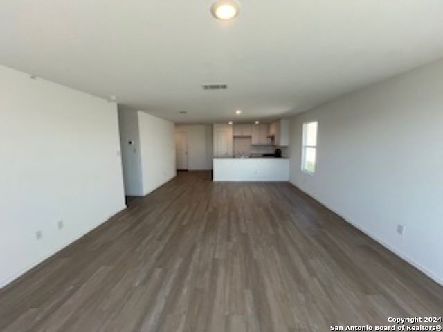 unfurnished living room featuring dark hardwood / wood-style floors