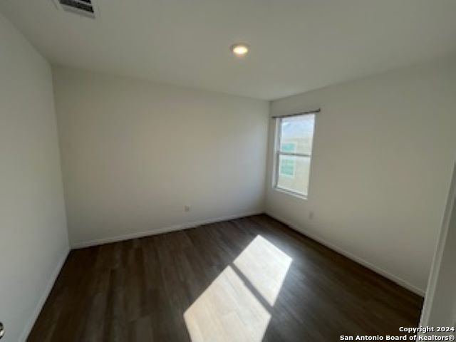 unfurnished room featuring dark hardwood / wood-style flooring