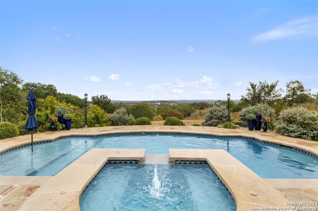 view of swimming pool with an in ground hot tub